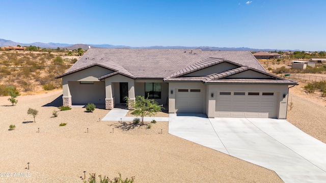 view of front of house featuring a garage and a mountain view