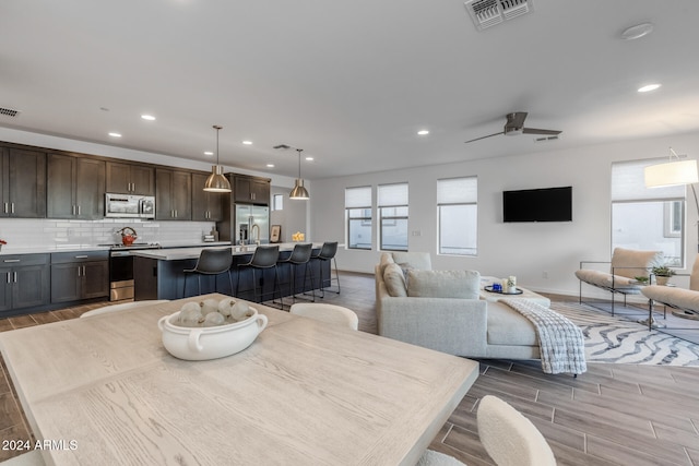 dining area featuring light hardwood / wood-style flooring and ceiling fan