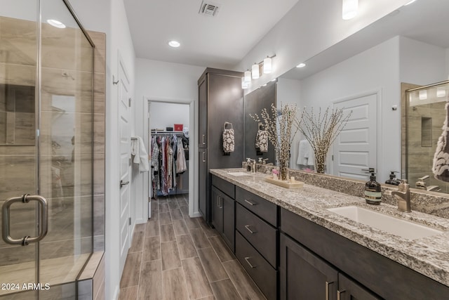 bathroom featuring vanity and an enclosed shower