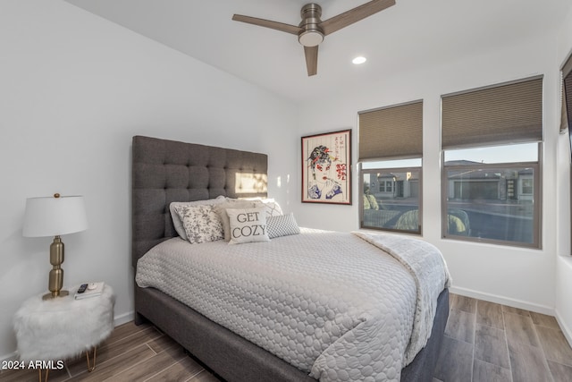 bedroom with ceiling fan and hardwood / wood-style flooring