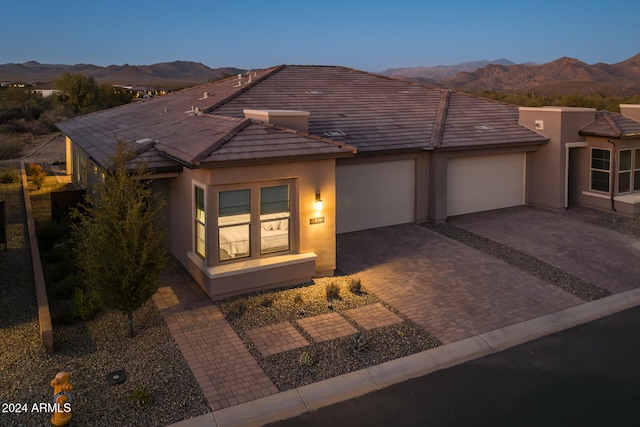 view of front of property featuring a mountain view and a garage