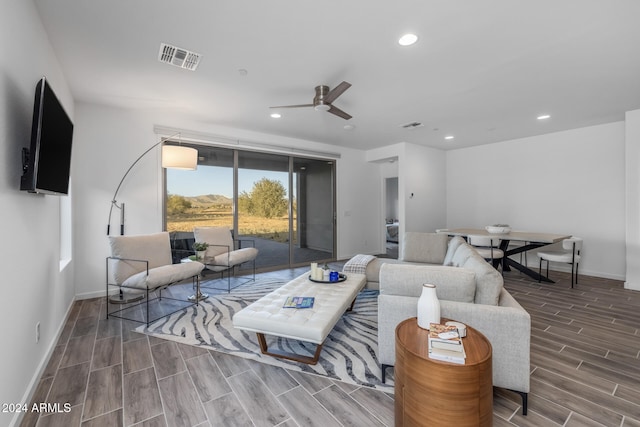 living room with hardwood / wood-style flooring and ceiling fan