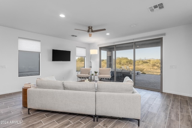 living room with ceiling fan and wood-type flooring