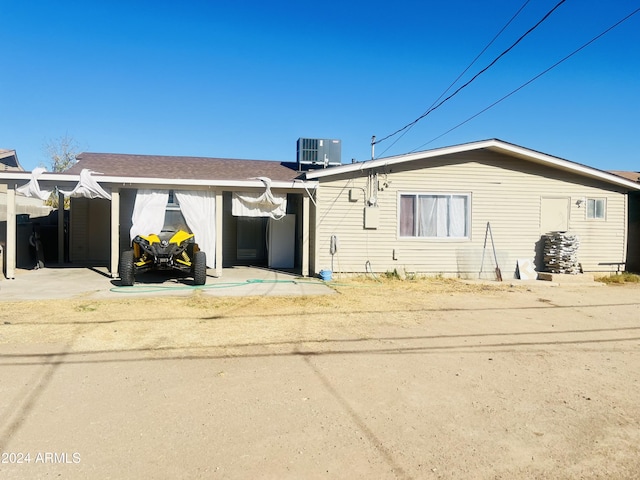 rear view of house featuring central AC