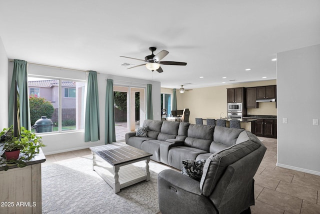 living room with ceiling fan and sink