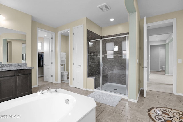 full bathroom with tile patterned flooring, vanity, separate shower and tub, and toilet