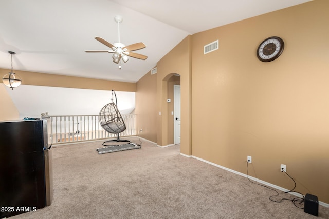 workout room with arched walkways, lofted ceiling, carpet flooring, visible vents, and baseboards