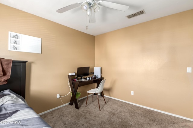 office space with carpet, visible vents, ceiling fan, and baseboards