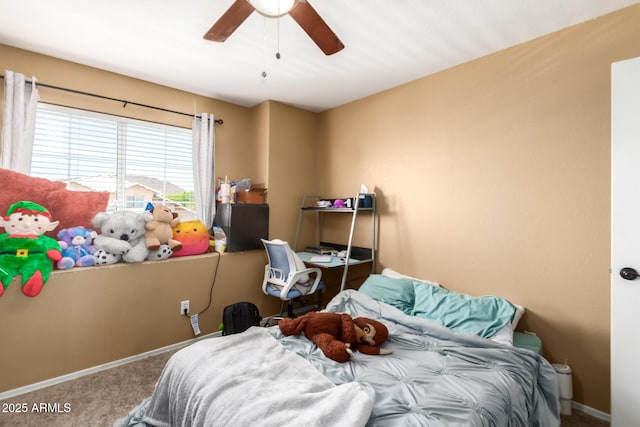 carpeted bedroom featuring a ceiling fan and baseboards