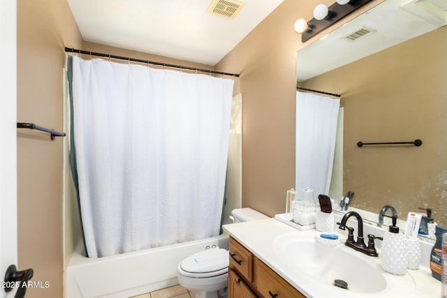 bathroom featuring toilet, vanity, visible vents, and tile patterned floors