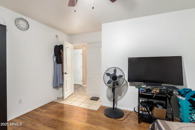 bedroom featuring ceiling fan, light wood-type flooring, and baseboards