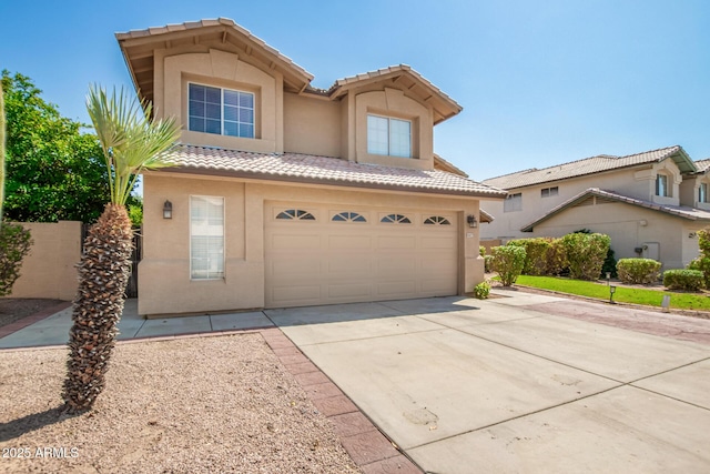 view of front of property featuring an attached garage, stucco siding, concrete driveway, and a tiled roof