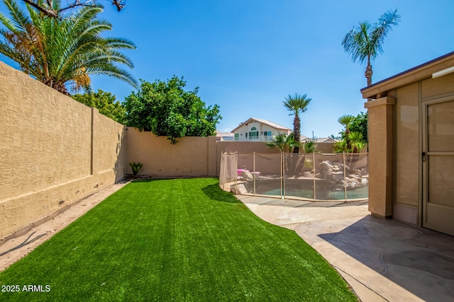 view of yard with a fenced backyard and a patio