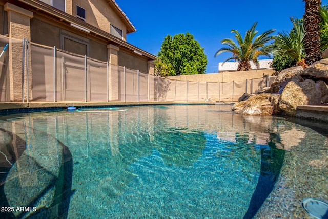 view of swimming pool with a fenced in pool and fence