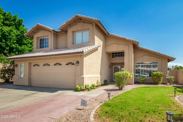 view of front of house with driveway, a garage, stucco siding, a tiled roof, and a front yard