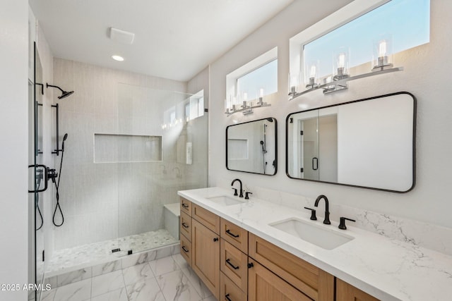 bathroom with a shower with door and vanity