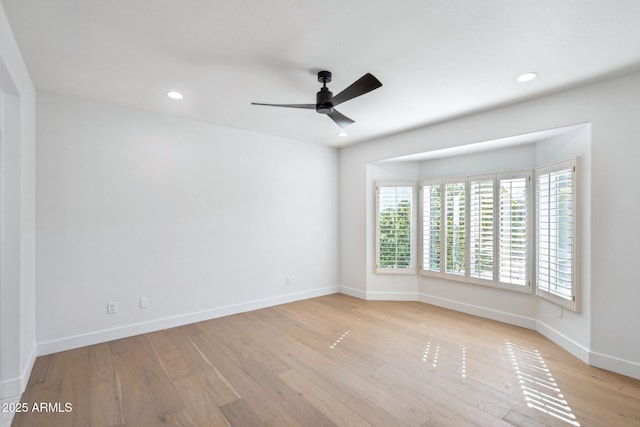 empty room featuring light hardwood / wood-style flooring and ceiling fan