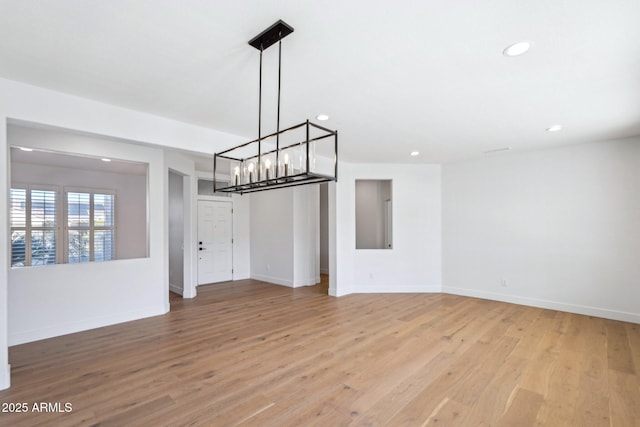 unfurnished dining area featuring light wood-type flooring