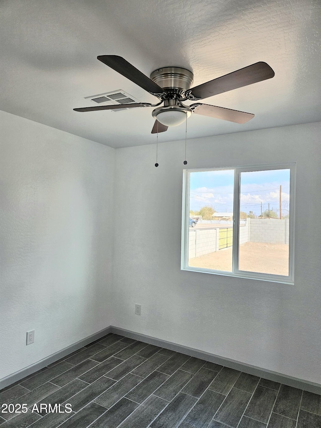 empty room featuring ceiling fan and a textured ceiling