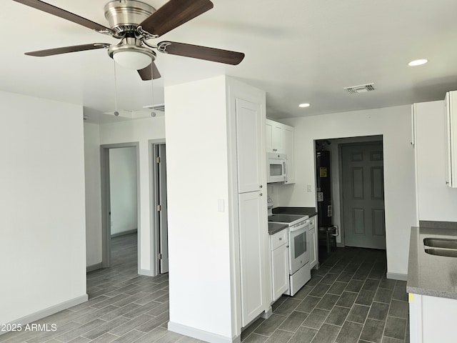 kitchen featuring white appliances, sink, and white cabinets