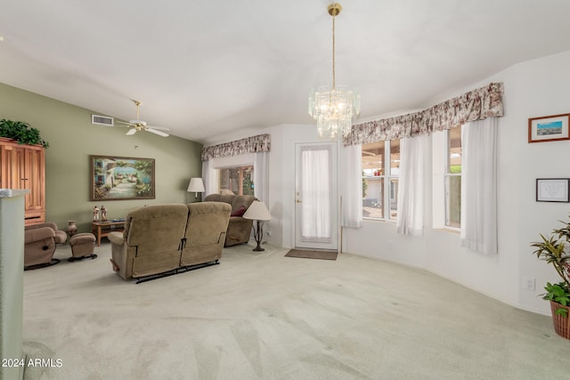 living room featuring ceiling fan with notable chandelier and light colored carpet