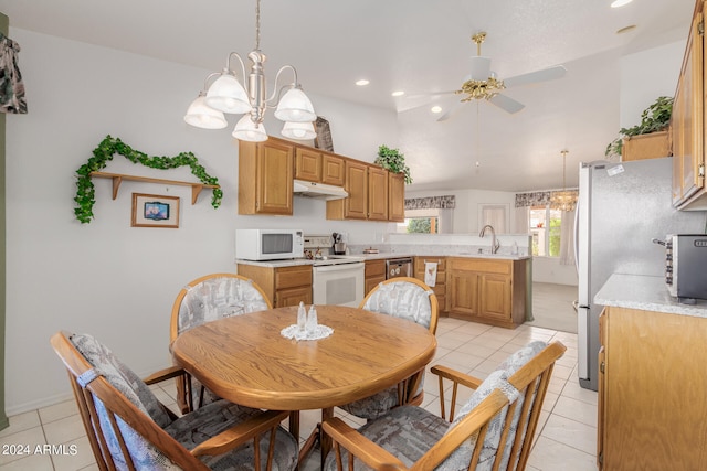 tiled dining room with ceiling fan with notable chandelier and sink