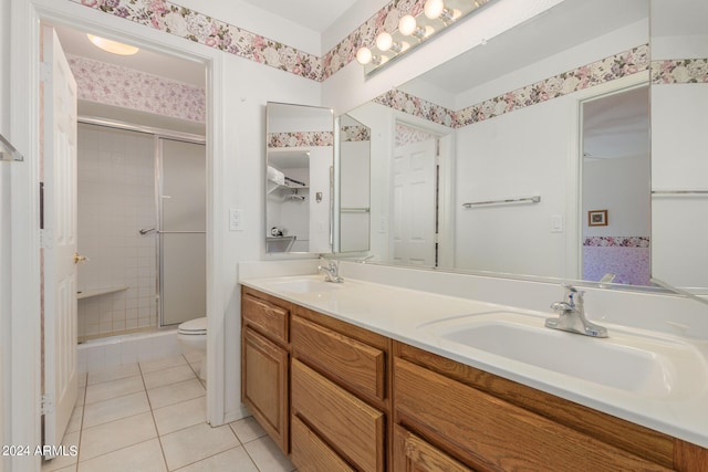 bathroom with vanity, tile patterned flooring, toilet, and a shower with shower door