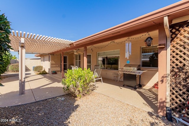 back of property featuring a pergola, ceiling fan, and a patio