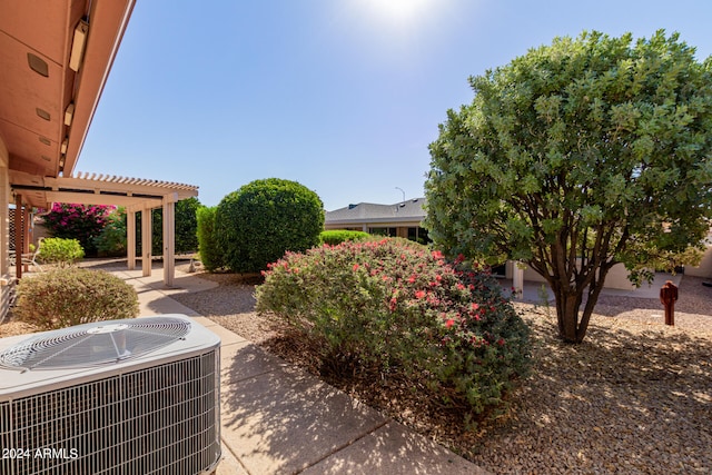 view of yard featuring a patio, a pergola, and central AC unit