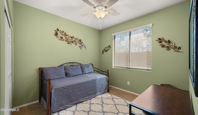 bedroom with ceiling fan and light tile patterned floors