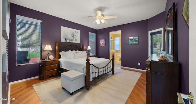 bedroom featuring ensuite bathroom, light hardwood / wood-style flooring, and ceiling fan