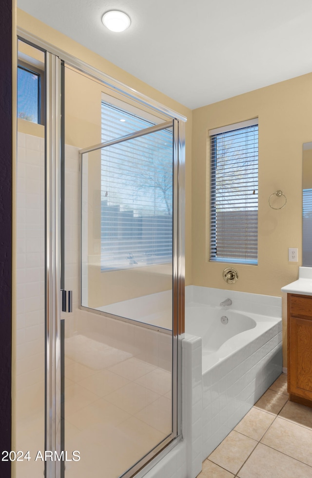 bathroom with tile patterned flooring, vanity, and separate shower and tub