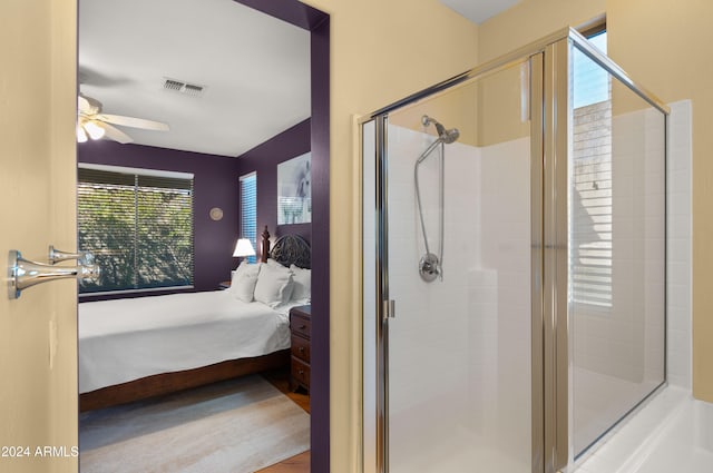 bathroom featuring ceiling fan and an enclosed shower