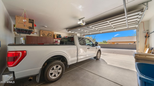 garage featuring a garage door opener and gas water heater