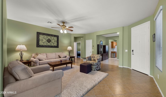 tiled living room featuring ceiling fan