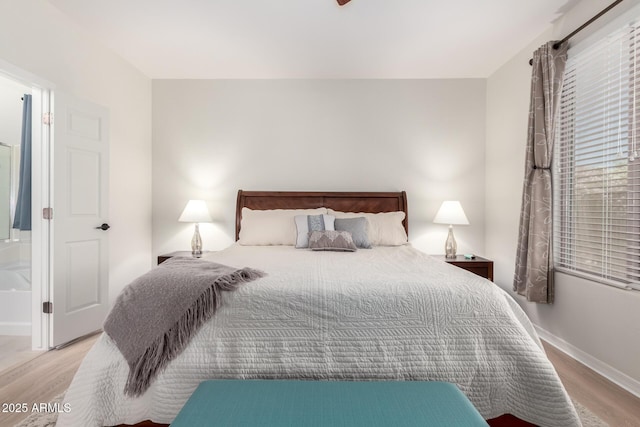 bedroom featuring wood finished floors and baseboards