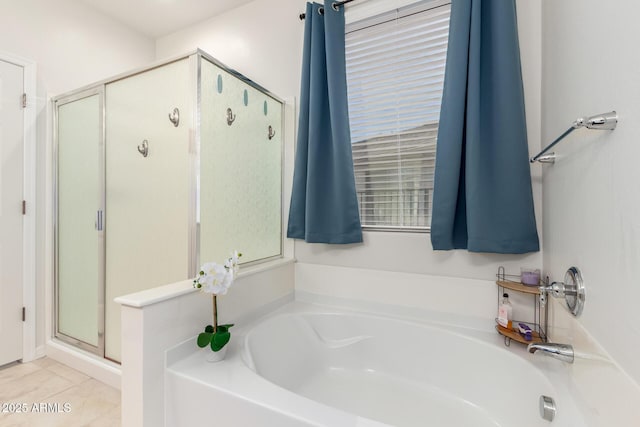 bathroom with tile patterned floors, a shower stall, and a bath
