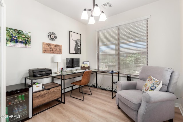 office space with wine cooler, visible vents, and wood finished floors