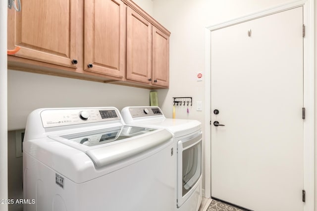 laundry room featuring cabinet space and washer and clothes dryer