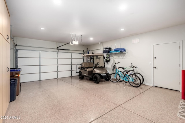 garage featuring a garage door opener and recessed lighting