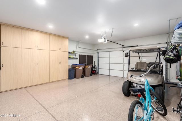 garage featuring recessed lighting and a garage door opener