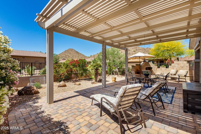 view of patio / terrace with a mountain view, a fenced backyard, and a pergola