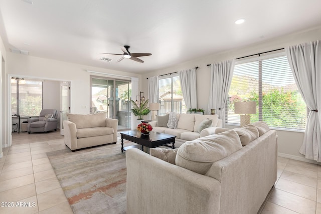 living area with visible vents, light tile patterned floors, and ceiling fan