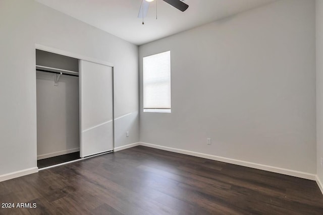 unfurnished bedroom featuring dark hardwood / wood-style flooring, a closet, and ceiling fan