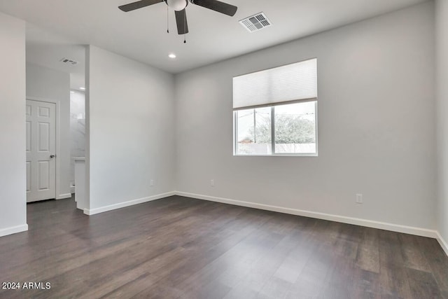 empty room with dark wood-type flooring and ceiling fan