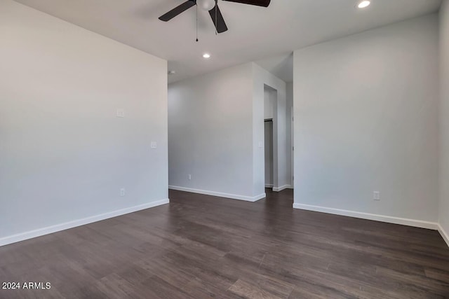 empty room featuring ceiling fan and dark hardwood / wood-style flooring