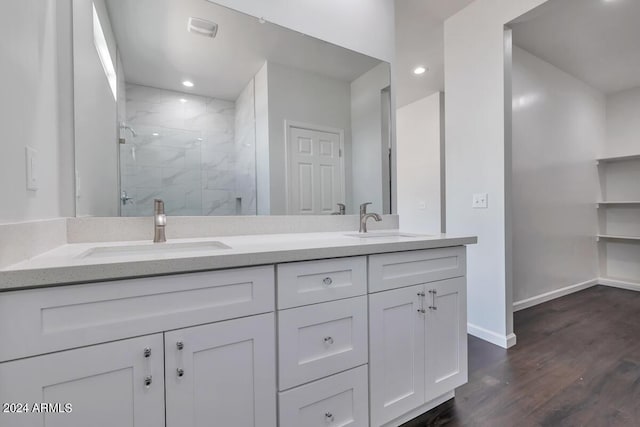 bathroom featuring vanity, wood-type flooring, and a shower with door