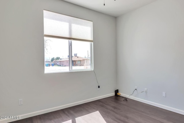 unfurnished room with dark hardwood / wood-style flooring