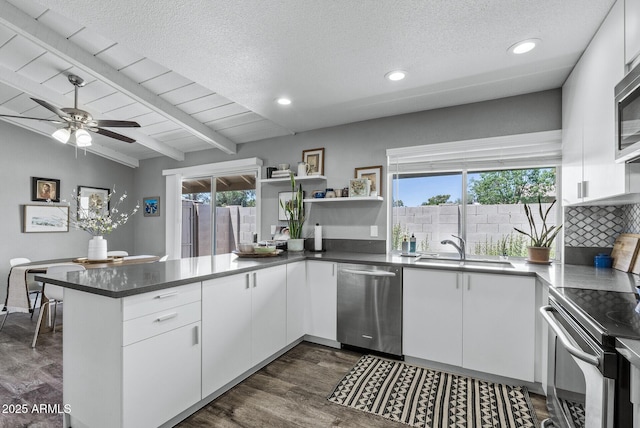 4502 W Continental Dr, Glendale, AZ 85308 - kitchen featuring stainless steel appliances, a sink, a peninsula, white cabinetry, and a ceiling fan