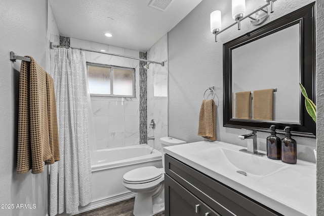 4502 W Continental Dr, Glendale, AZ 85308 - full bathroom featuring toilet, vanity, shower / tub combo with curtain, wood finished floors, and a textured ceiling